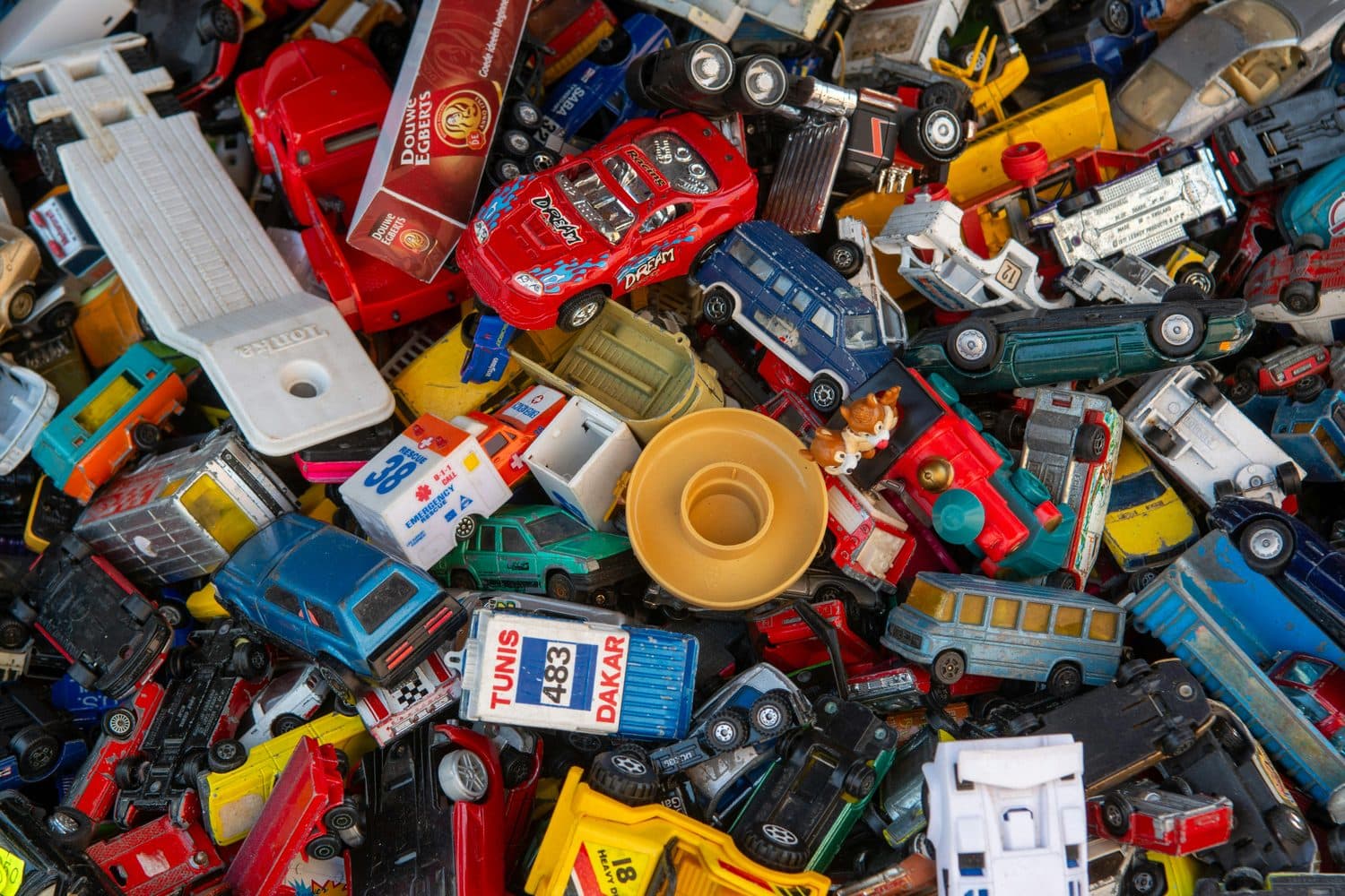 A large pile of discarded plastic toy cars